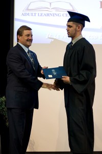 Male graduate receiving diploma