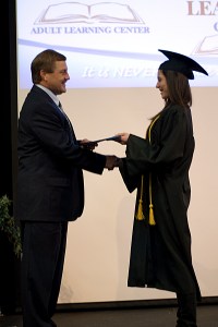 Female graduate receiving diploma
